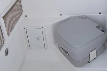 Slide: The Image of Manufacturer Provided Image: Portable toilet in the 2020 Everglades 253 Center Console boat. - 15