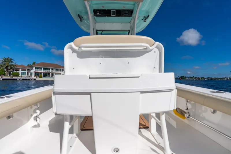 Slide: The Image of 2020 Everglades 253 Center Console boat interior with clear blue sky and waterfront view. - 39