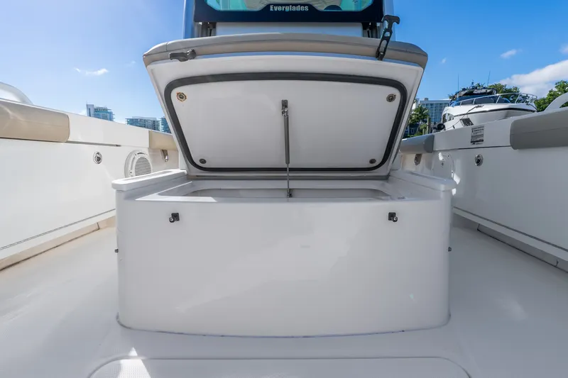Slide: The Image of Open storage compartment on 2020 Everglades 253 Center Console boat, under clear blue sky. - 34