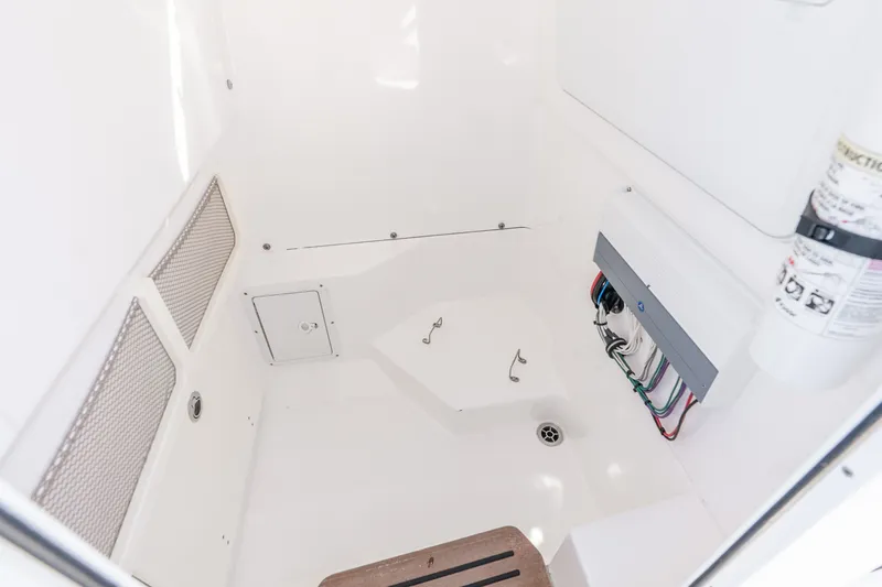 Slide: The Image of Interior of 2020 Everglades 253 Center Console boat, featuring storage and wiring. - 52
