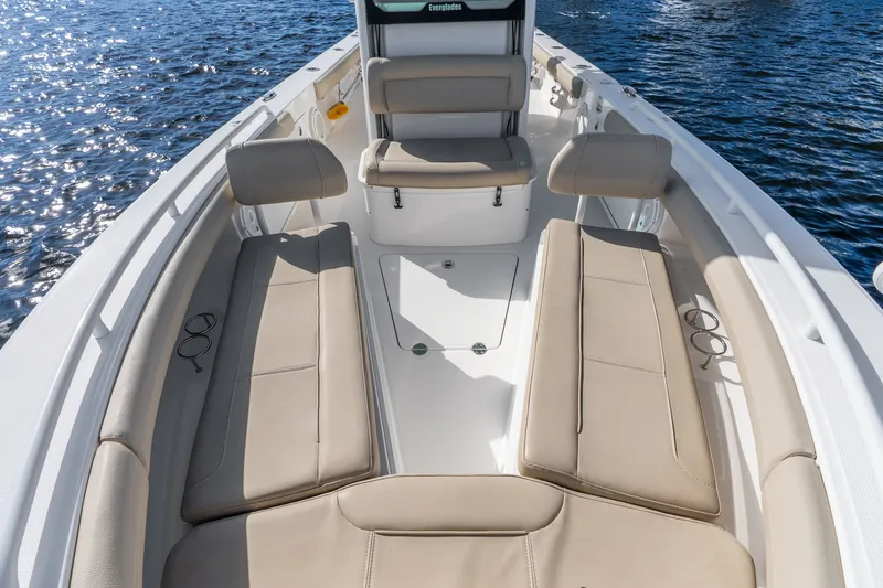 Slide: The Image of 2020 Everglades 253 Center Console boat interior with beige seating on water. - 32