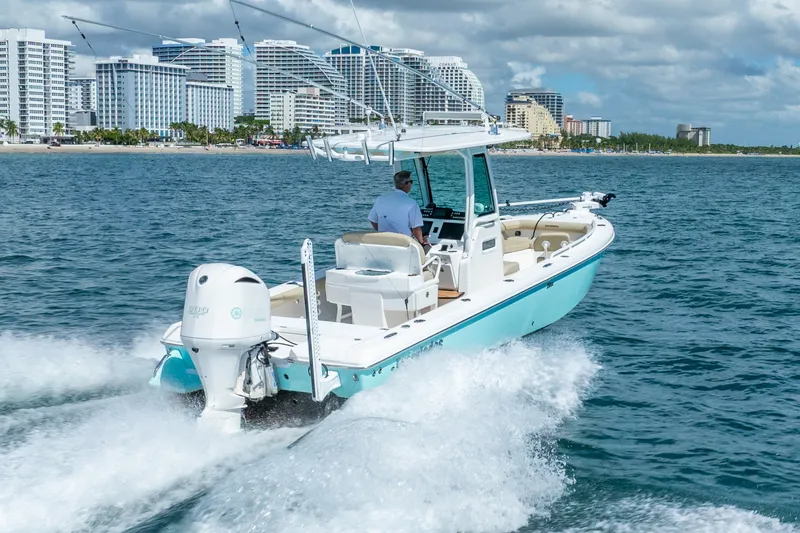 Slide: The Image of 2020 Everglades 253 Center Console boat cruising near city skyline. - 18