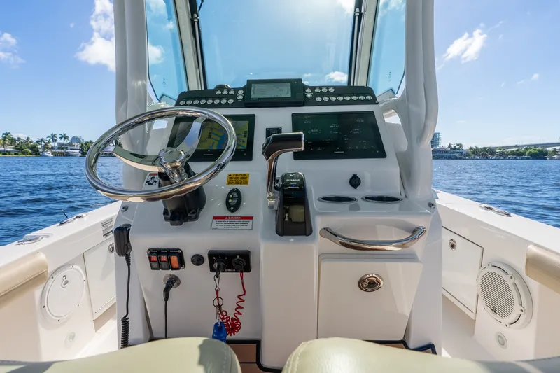 Slide: The Image of Cockpit view of 2020 Everglades 253 Center Console boat on water. - 21