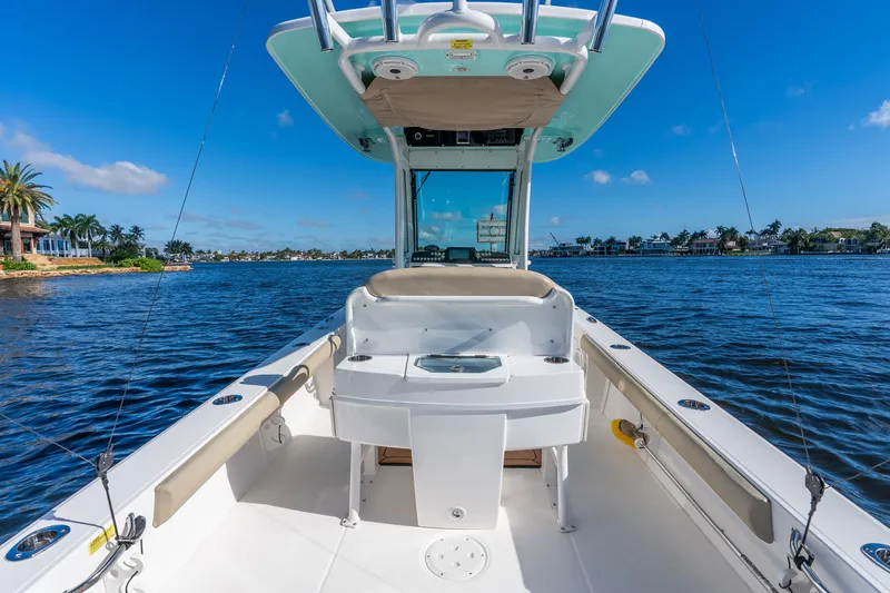 Slide: The Image of 2020 Everglades 253 Center Console boat on a sunny day, cruising on calm waters. - 38