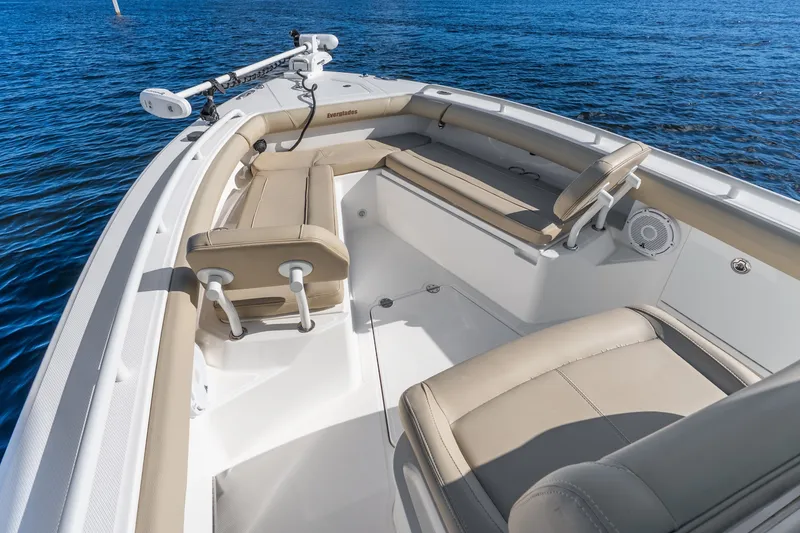 Slide: The Image of 2020 Everglades 253 Center Console boat interior with beige seating on blue water. - 30
