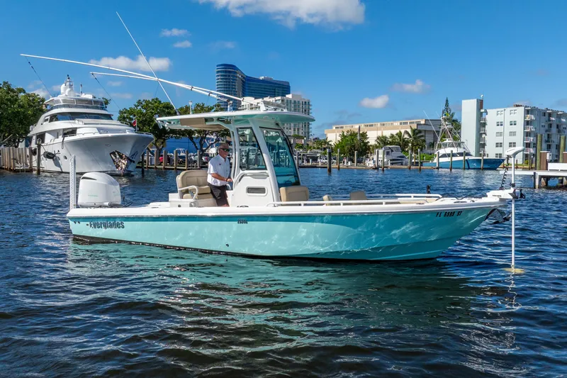 The Image of 2020 Everglades 253 Center Console boat on water, with marina and buildings in background. - 1