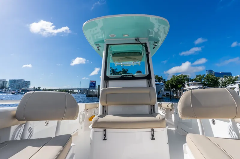 Slide: The Image of 2020 Everglades 253 Center Console boat interior with seating, under clear blue sky. - 31