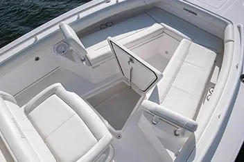 Slide: The Image of Manufacturer Provided Image: 2020 Everglades 253 Center Console boat interior with white seating and storage compartment. - 6