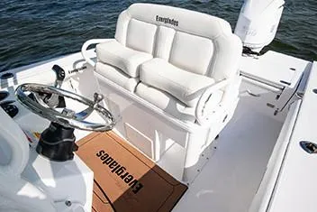 Slide: The Image of Manufacturer Provided Image: 2020 Everglades 253 Center Console boat interior with white seating and steering wheel. - 8
