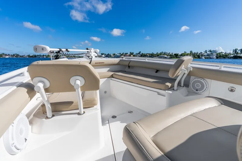 Slide: The Image of 2020 Everglades 253 Center Console boat interior with beige seating on a sunny day. - 28
