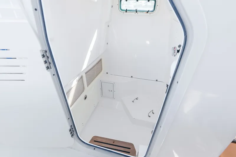 Slide: The Image of Interior cabin of 2020 Everglades 253 Center Console boat, featuring white finish and window. - 51