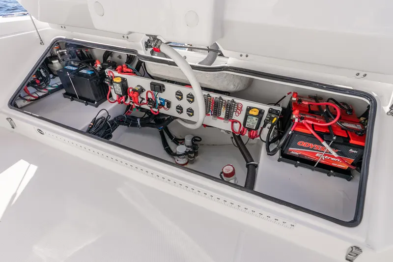 Slide: The Image of Electrical compartment of 2020 Everglades 253 Center Console boat, showcasing batteries and wiring. - 50