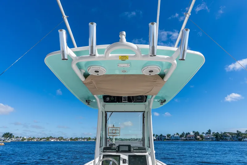 Slide: The Image of 2020 Everglades 253 Center Console boat on water under clear blue sky. - 26