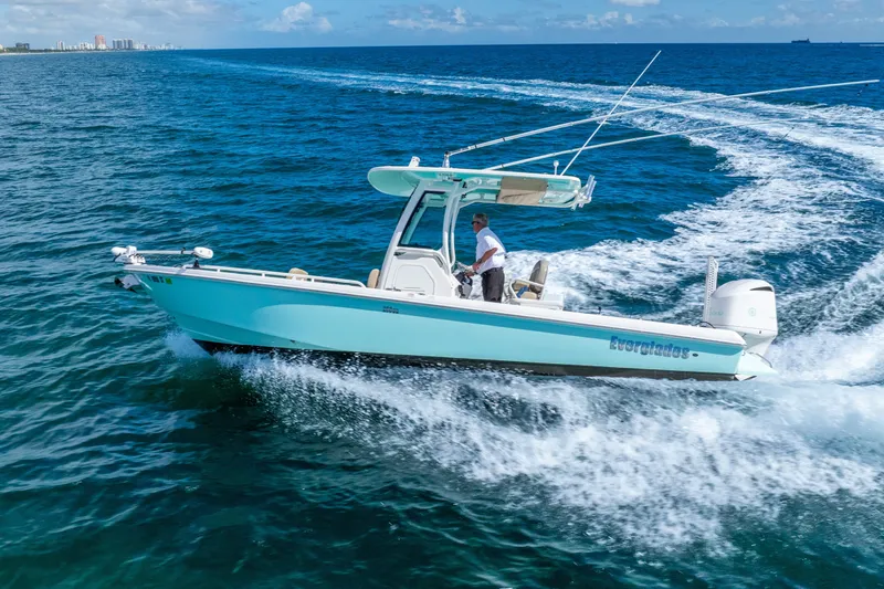 Slide: The Image of 2020 Everglades 253 Center Console boat cruising on open ocean waters. - 16