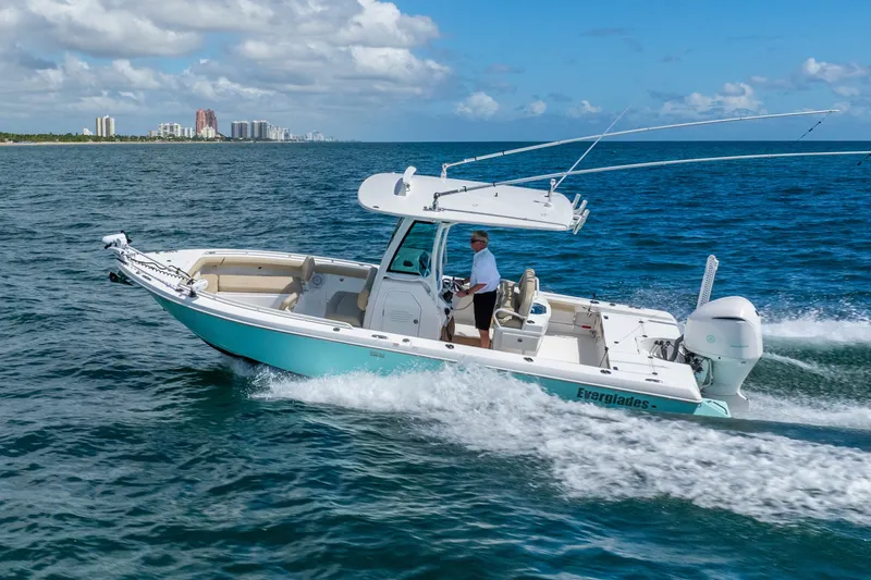 Slide: The Image of 2020 Everglades 253 Center Console boat cruising on open water under blue skies. - 19