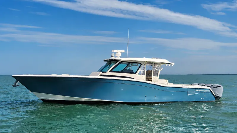 Slide: The Image of 2022 Grady-White Canyon 456 on calm water with a blue sky. - 6