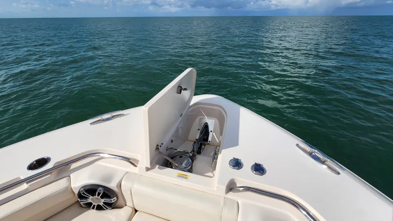 Slide: The Image of The image shows the bow of a 2022 Grady-White Canyon 456 boat on calm water. - 18