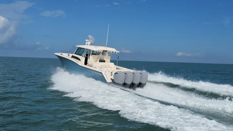 Slide: The Image of A 2022 Grady-White Canyon 456 speeds across the sea with four outboard engines. - 4