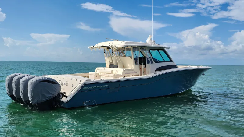 Slide: The Image of 2022 Grady-White Canyon 456 on calm water with four outboard engines. - 9