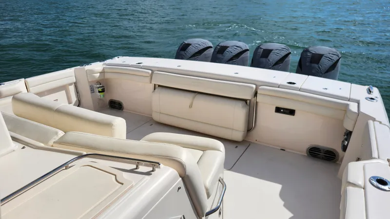 Slide: The Image of The image shows the spacious aft deck of a 2022 Grady-White Canyon 456 with four engines. - 23