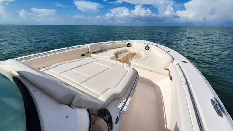 Slide: The Image of The image shows the bow of a Grady-White Canyon 456 boat on calm waters. - 15
