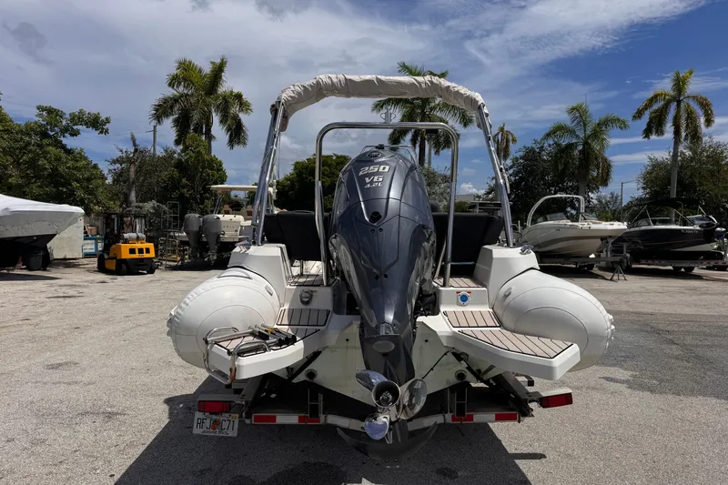 Slide: The Image of 2022 Zodiac Medline 6.8 boat with powerful outboard motor in a sunny marina setting. - 4