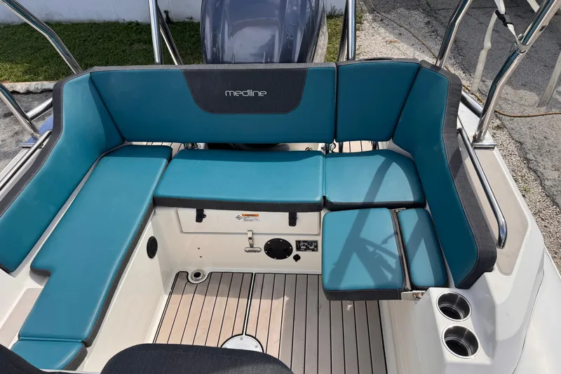 Slide: The Image of 2022 Zodiac Medline 6.8 boat interior with blue seating and cup holders. - 12
