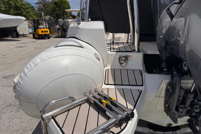 Slide: The Image of 2022 Zodiac Medline 6.8 boat with inflatable tube and motor, docked outdoors. - 7