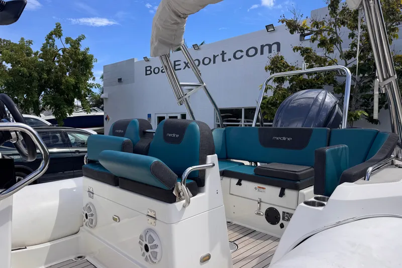 Slide: The Image of 2022 Zodiac Medline 6.8 boat interior with teal seating at Boat Export location. - 10