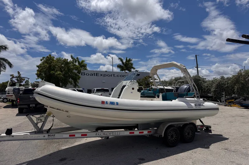 Slide: The Image of 2022 Zodiac Medline 6.8 boat on trailer under a sunny sky. - 1