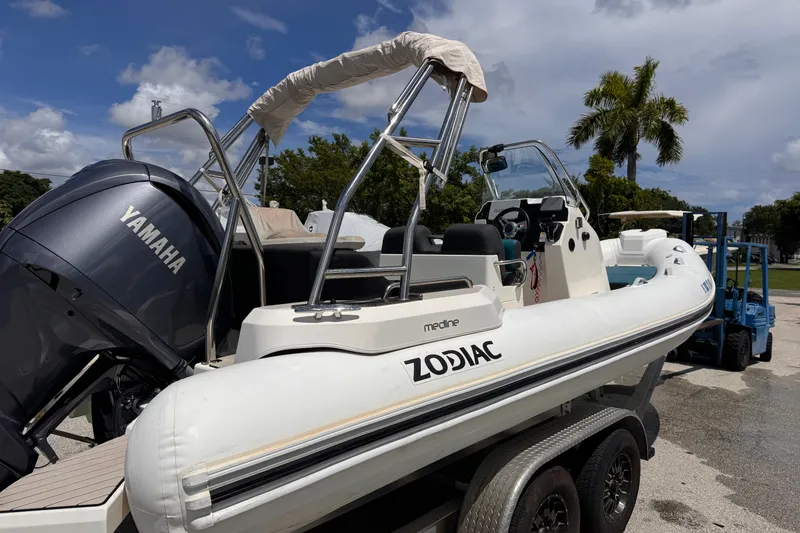 Slide: The Image of 2022 Zodiac Medline 6.8 boat with Yamaha engine on trailer, parked outdoors. - 5