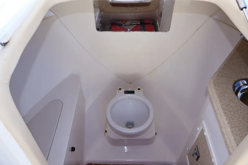 Slide: The Image of Compact marine bathroom in 2010 Deep Impact 330 C boat, featuring a toilet and storage space. - 40