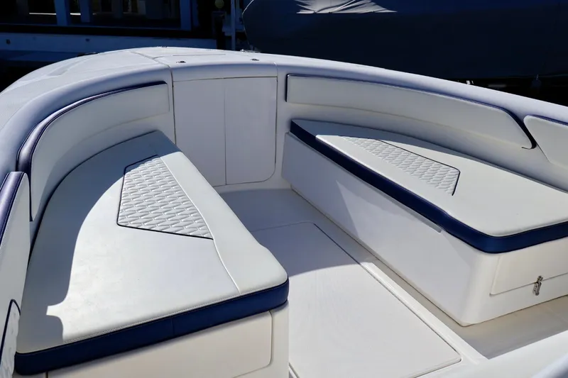 Slide: The Image of Luxury seating area on a 2010 Deep Impact 330 C boat, featuring white and blue upholstery. - 38