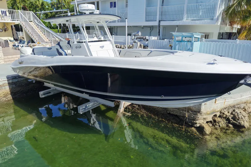 The Image of Deep Impact 330 C boat from 2010 on a lift by waterfront home. - 1