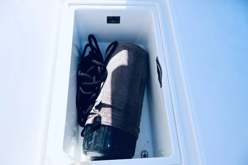 Slide: The Image of Storage compartment on 2010 Deep Impact 330 C boat with rope and fender. - 44