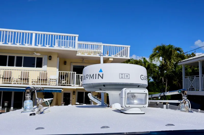 Slide: The Image of Boat with Garmin radar, Deep Impact 330 C, 2010 model, near a coastal building. - 42