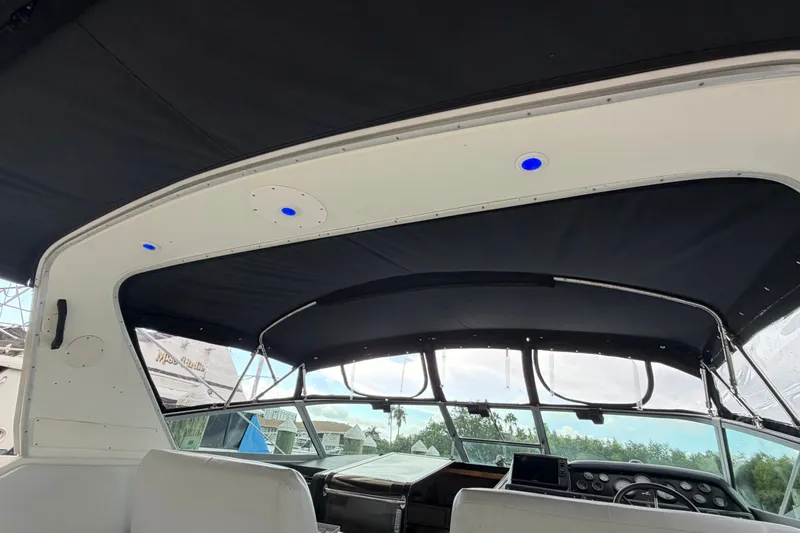 Slide: The Image of Interior view of 1993 Sea Ray 400 Express Cruiser with black canopy and blue LED lights. - 10