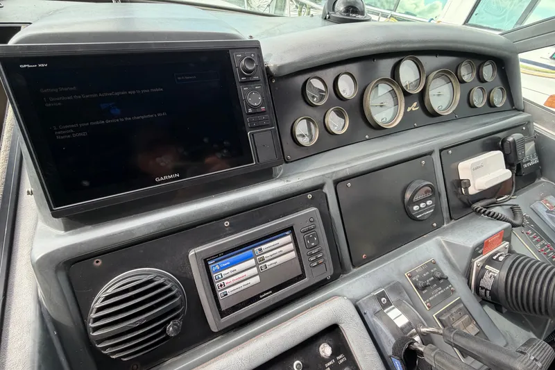 Slide: The Image of 1993 Sea Ray 400 Express Cruiser dashboard with Garmin navigation and control panels. - 11