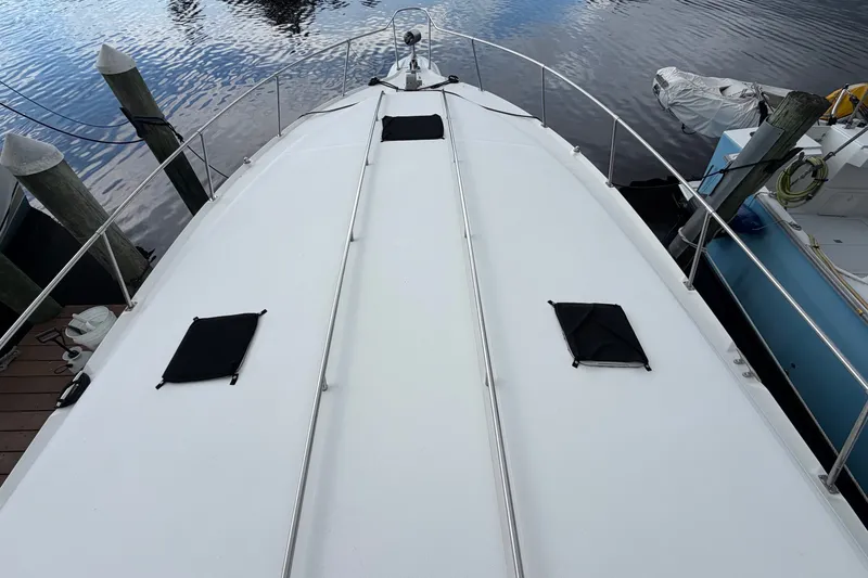 Slide: The Image of 1993 Sea Ray 400 Express Cruiser docked, view of the bow and deck area. - 3