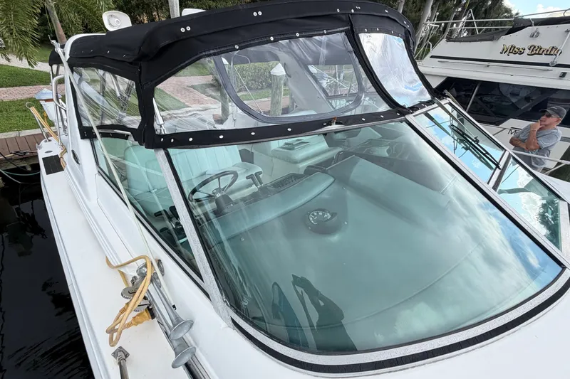 Slide: The Image of 1993 Sea Ray 400 Express Cruiser with black canopy and sleek windshield design. - 6