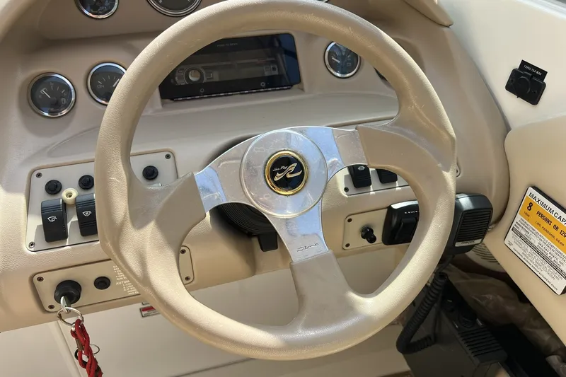 Slide: The Image of Steering wheel and dashboard of a 1997 Sea Ray 240 Overnighter boat. - 16