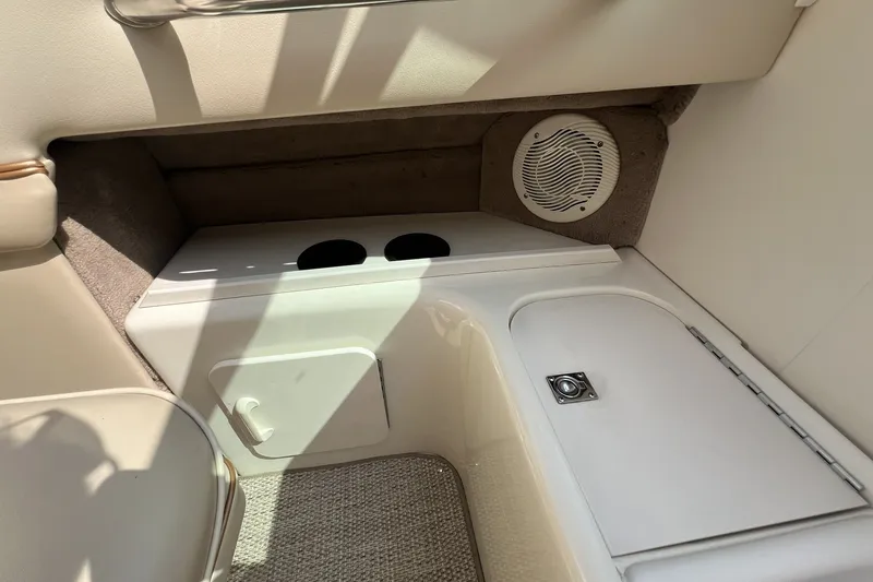 Slide: The Image of Interior of a 1997 Sea Ray 240 Overnighter boat, featuring storage compartments and speaker. - 39
