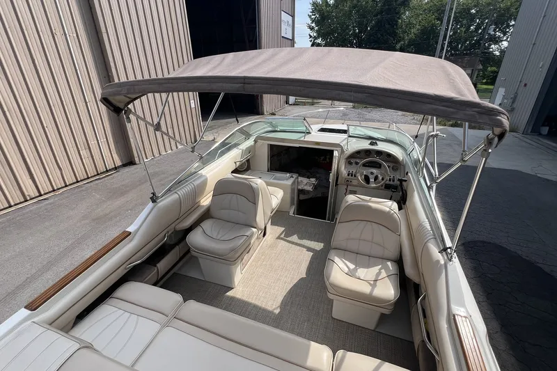Slide: The Image of 1997 Sea Ray 240 Overnighter boat interior with seating and canopy. - 43