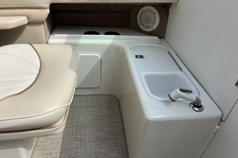 Slide: The Image of Interior of a 1997 Sea Ray 240 Overnighter boat with seating and sink area. - 24