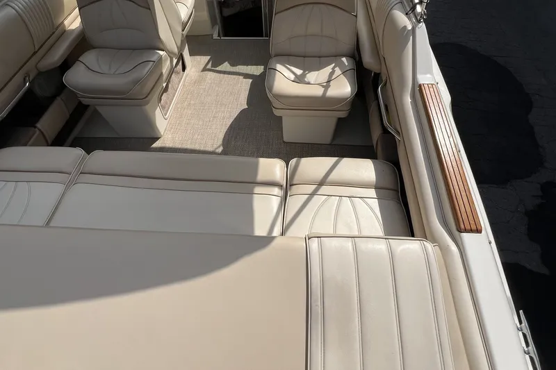 Slide: The Image of Interior of a 1997 Sea Ray 240 Overnighter boat with beige seating. - 42