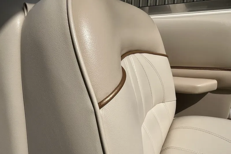 Slide: The Image of 1997 Sea Ray 240 Overnighter boat interior with beige leather seating detail. - 27