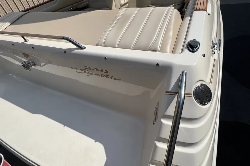 Slide: The Image of 1997 Sea Ray 240 Overnighter boat with beige seating and stainless steel railings. - 66