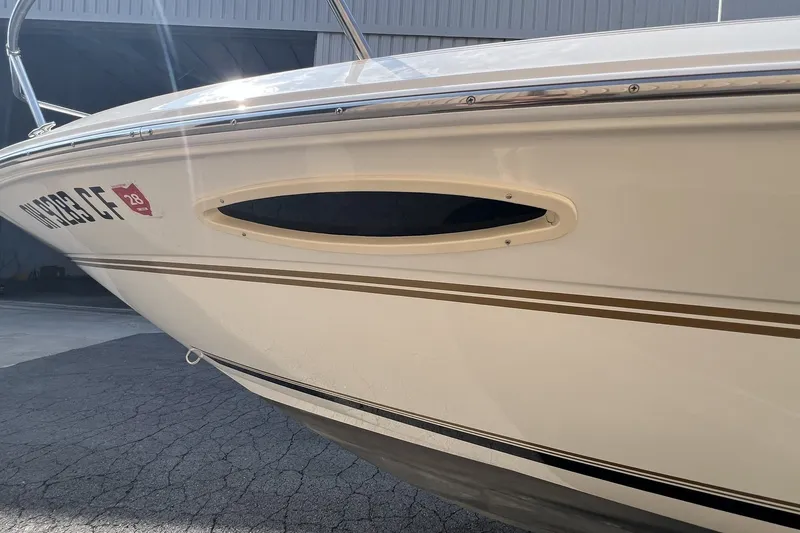 Slide: The Image of 1997 Sea Ray 240 Overnighter boat side view with registration number visible. - 78