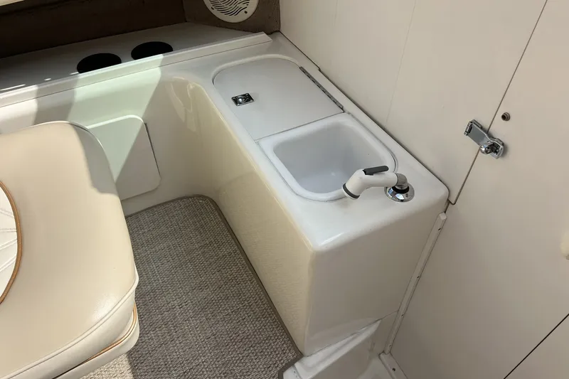Slide: The Image of Interior of 1997 Sea Ray 240 Overnighter boat with sink and seating area. - 23