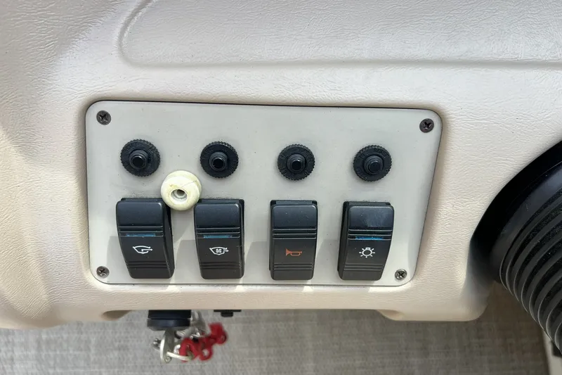 Slide: The Image of Control panel of a 1997 Sea Ray 240 Overnighter boat with switches and knobs. - 13